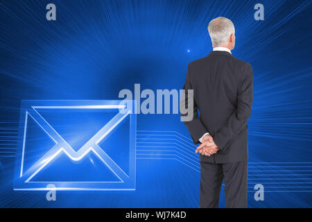 Composite image of rear view of mature businessman posing on white background Stock Photo
