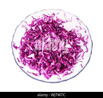 top view of salad from chopped red cabbage with vegetable oil in glass bowl cutout on white background Stock Photo