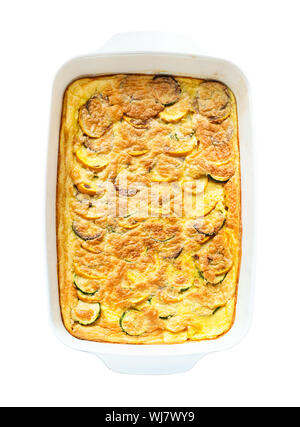 french cuisine - top view of baked omelette with Zucchini vegetable in ceramic baking dish cutout on white background Stock Photo
