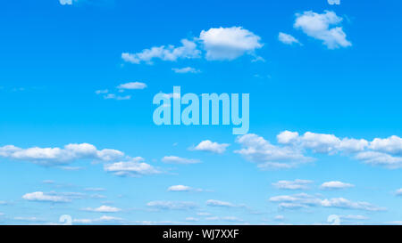 panoramic view of light cumuli clouds in blue sky on sunny august day Stock Photo