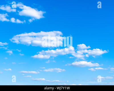 light cumuli clouds in blue sky on sunny august day Stock Photo