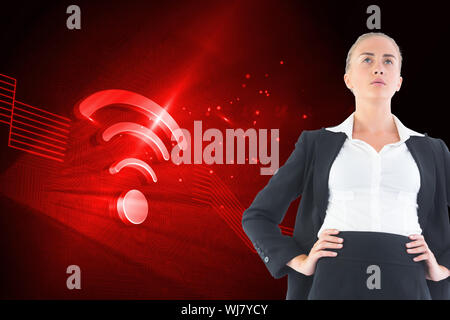 Composite image of blonde businesswoman standing with hands on hips Stock Photo