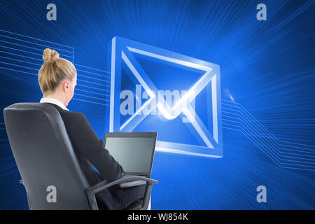 Composite image of blonde businesswoman sitting on swivel chair with laptop Stock Photo