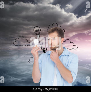 Composite image of handsome model on white background holding a bulb Stock Photo