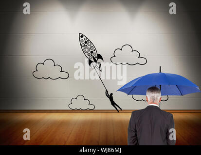 Composite image of mature businessman holding umbrella Stock Photo
