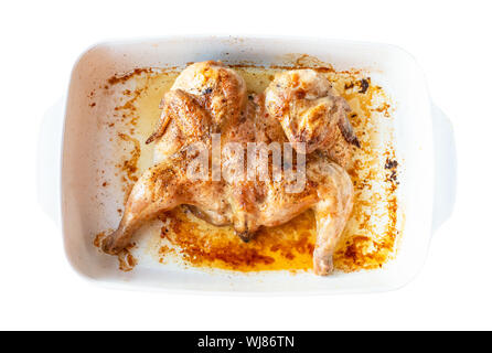 georgian cuisine - top view of flattened fried chicken tabaka in baked dish cutout on white background Stock Photo