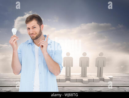 Composite image of charming model on white background holding a bulb in right hand on white background Stock Photo