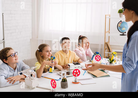 Stem education. Scientist explaining new material to children Stock Photo