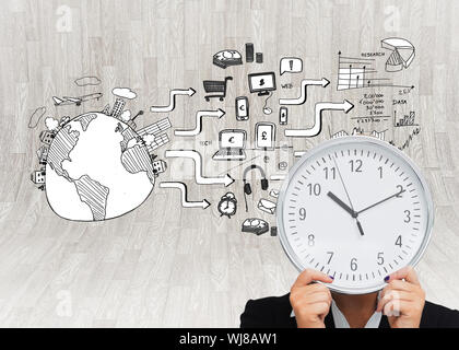 Composite image of businesswoman in suit holding a clock Stock Photo