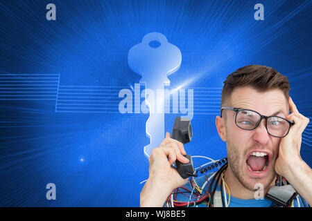 Composite image of portrait of frustrated computer engineer screaming while on call in front of open cpu Stock Photo