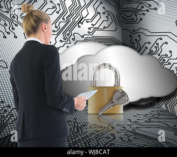 Composite image of blonde businesswoman holding tablet Stock Photo