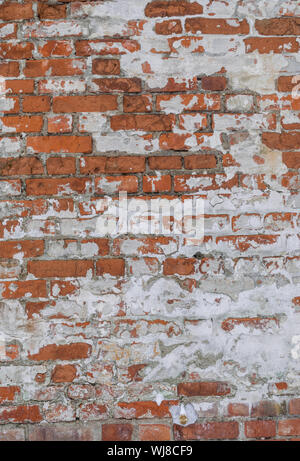 orange wheathered brick wall with snow Stock Photo