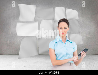 Composite image of serious classy businesswoman using calculator Stock Photo
