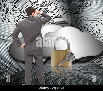 Composite image of businessman standing hand on hip peering Stock Photo