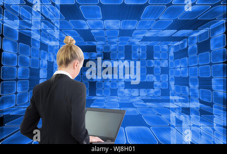 Composite image of blonde businesswoman using laptop Stock Photo