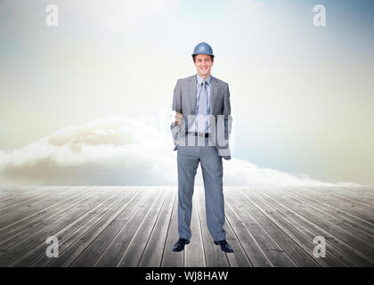 Composite image of smiling attractive architect on phone holding plans Stock Photo