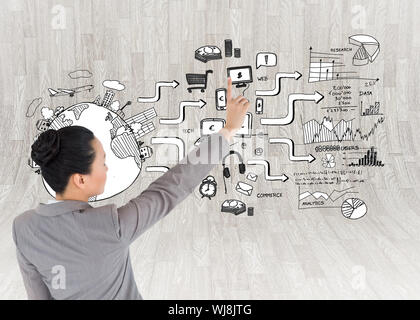 Composite image of asian businesswoman pointing Stock Photo
