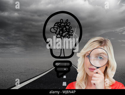 Composite image of fair-haired woman looking through a magnifying glass Stock Photo