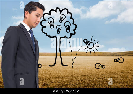 Composite image of light bulb tree over countryside Stock Photo
