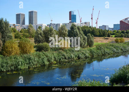 Central Stratford and East Village, East London UK, viewed from the Queen Elizabeth Olympic Park, with the River Lea in foreground Stock Photo