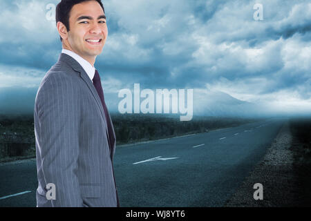 Composite image of smiling businessman standing Stock Photo