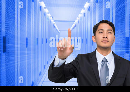 Composite image of stern asian businessman pointing Stock Photo