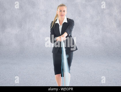 Composite image of blonde businesswoman pulling a rope Stock Photo
