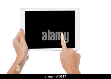 Womans finger pointing on tablet screen Stock Photo