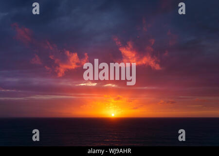 beautiful red dusk over the sea with sun rays Stock Photo
