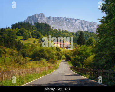 Road to Zaloa village in Orozko with Itxina mountain Stock Photo