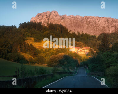 Road to Zaloa village in Orozko with Itxina mountain Stock Photo