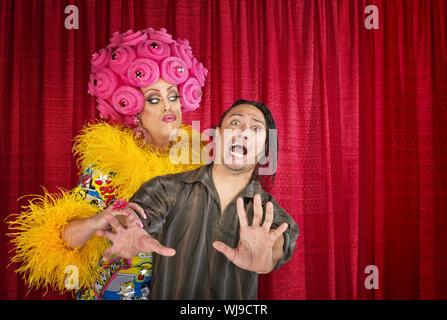 Big drag queen trying to kiss a scared man Stock Photo