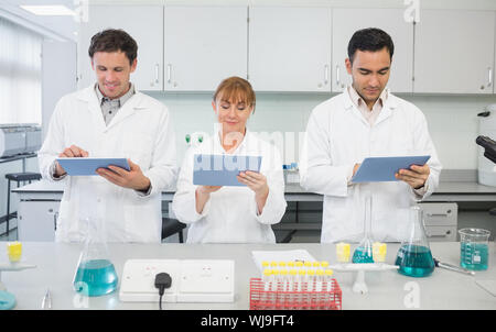 Group of serious scientists using tablet PCs in the laboratory Stock Photo