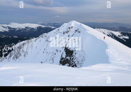 Extreme tourist walks along the ridge. Winter landscape in mountains Stock Photo