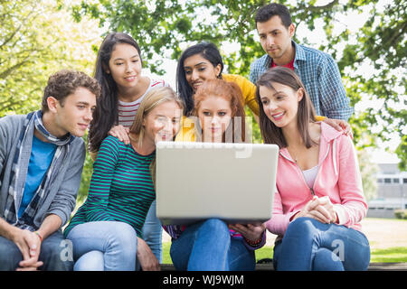 Group of young college students using laptop in the park Stock Photo