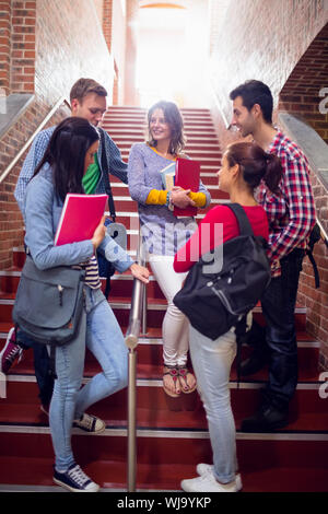 Group of young college students conversing on stairs in the college Stock Photo