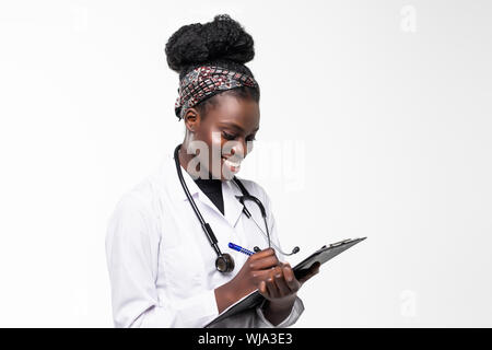 happy african medical intern doctor writing on clipboard Stock Photo