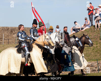 Mounted Knights parade in formation at the end of the Jousting Tournament at Dover Castle Stock Photo