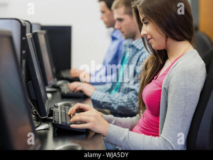 Side view of young students using computers in the computer room Stock Photo