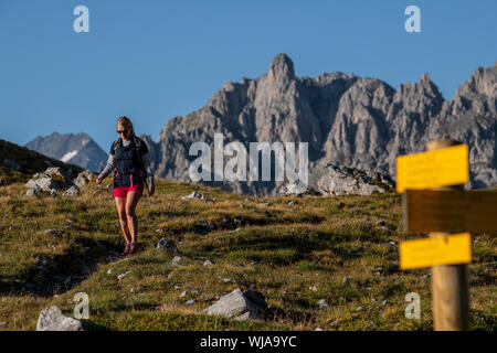 A woman hiking near the Lacs Merlet refuge in the Parc national de la Vanoise, La Vallee des Avals, Courchevel, French Alps. Stock Photo