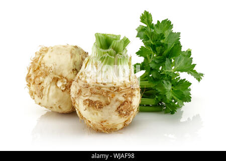Fresh celeriac root with celery stalks isolated background Stock Photo