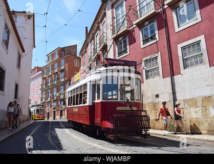 Lisbon, Portugal. August 2019. A vintage red tram in the streets of Baixa heading towards the old Town, Alfama Stock Photo