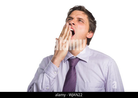 Young businessman in shirt and tie yawning Stock Photo