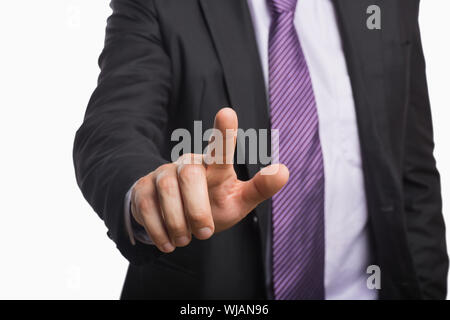 Businessman pointing against white background Stock Photo