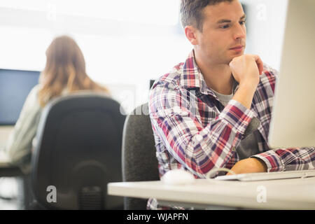 Focused student working in the computer room Stock Photo