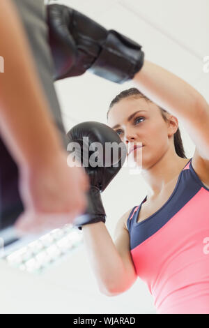 Determined female boxer focused on her training Stock Photo