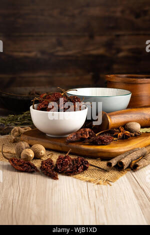Naga Ghost Pepper Chilli Pods  in a Bowl and with a kitchen setting Stock Photo