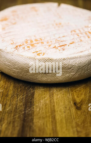 Detail of the French Le Marcaire cheese on the wooden table Stock Photo