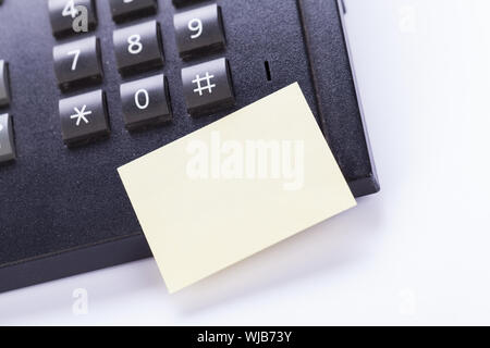 memo post it message on telefone in office reminder object business Stock Photo