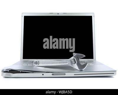 A spanner over a damaged laptop isolated over white background. Black copy space on screen. Stock Photo